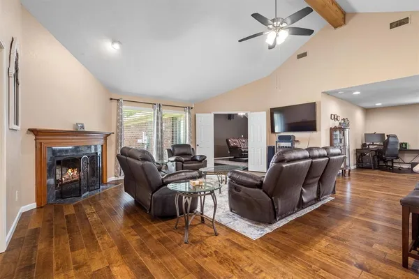 a living room with furniture a fireplace and a flat screen tv