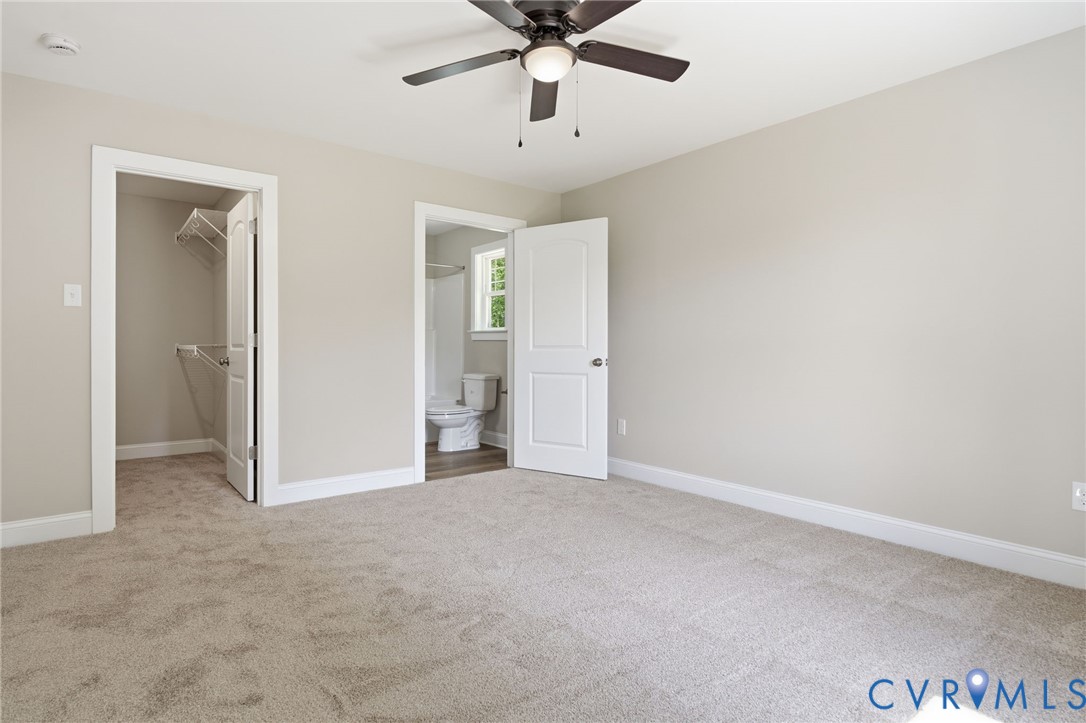 17557 Hewlett Road Beaverdam, VA 23015 - Photo 21 of 29 an empty room with chandelier fan and windows