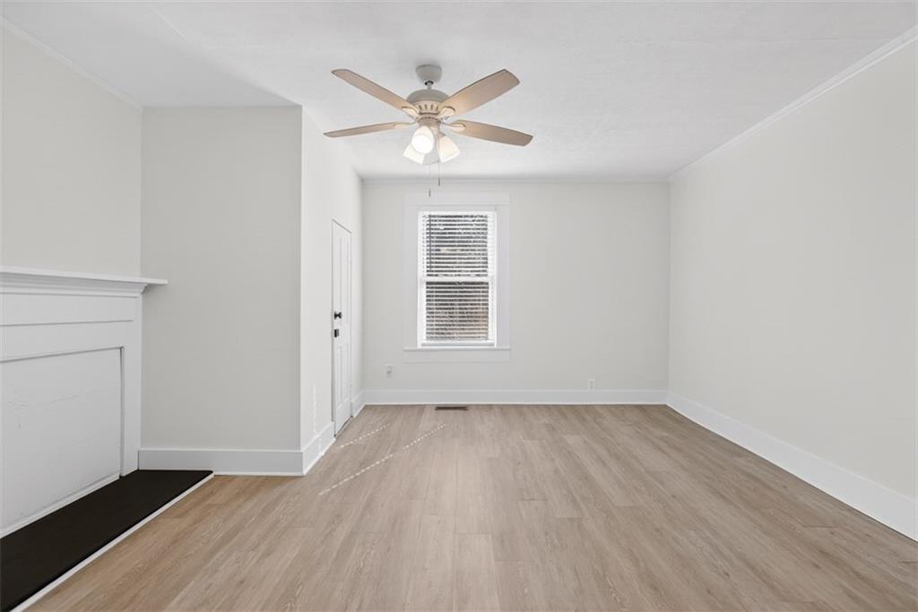 246 Spring Street Commerce, GA 30529 - Photo 9 of 23 wooden floor in an empty room with a window