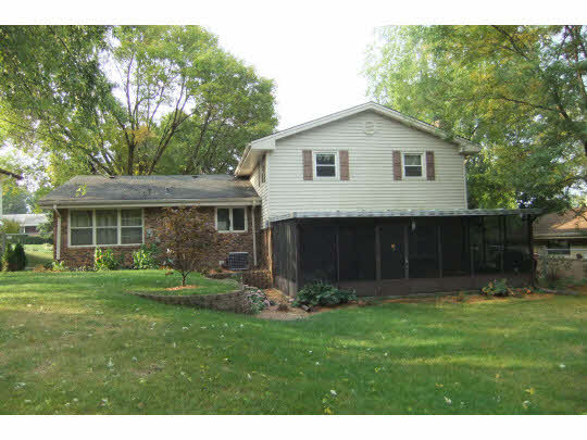 4854 Braewild Road Rockford, IL 61107 - Photo 11 of 11 a front view of house with a garden and trees