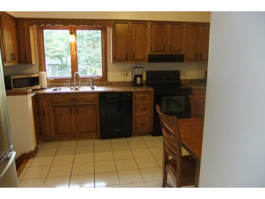 4854 Braewild Road Rockford, IL 61107 - Photo 5 of 11 a kitchen with a sink a stove and a microwave
