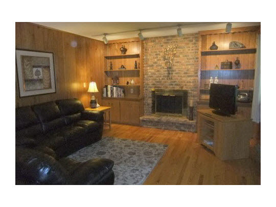 4854 Braewild Road Rockford, IL 61107 - Photo 6 of 11 a living room with fireplace furniture and a flat screen tv