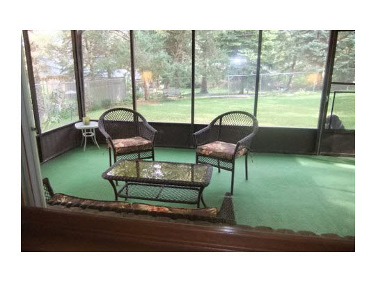 4854 Braewild Road Rockford, IL 61107 - Photo 7 of 11 a living room with a floor to ceiling window and a yard