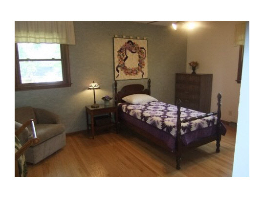 4854 Braewild Road Rockford, IL 61107 - Photo 10 of 11 a bedroom with a bed window and wall painting