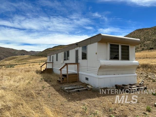 32214 Snake River Road Huntington, OR 97907 - Photo 16 of 31 View of property exterior featuring a mountain view and entry steps