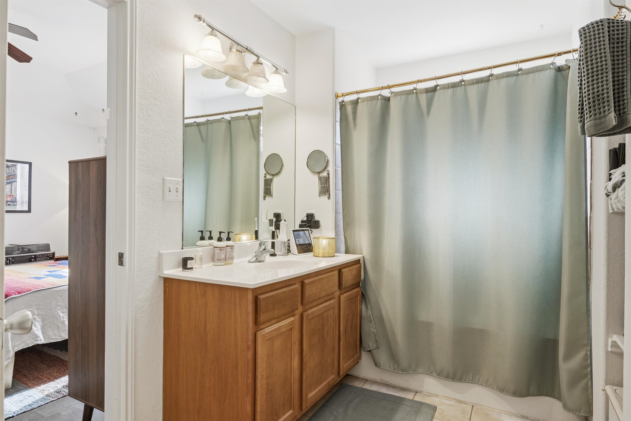 3015 Castro Street Austin, TX 78702 - Photo 28 of 40 A classic wood vanity and large mirror create a functional and inviting space in this bathroom.
