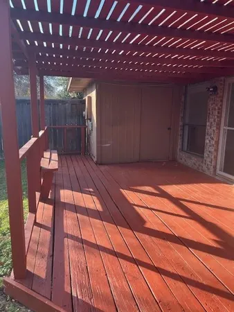 a view of a backyard with a garden and wooden fence