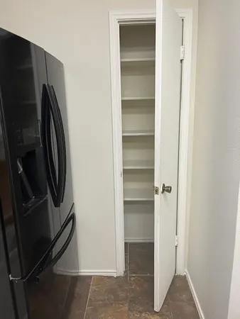 a view of walk in closet with empty racks