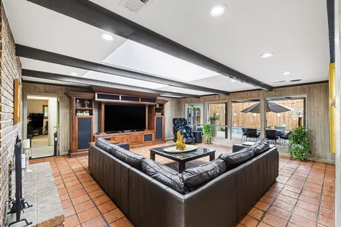a living room with furniture and flat screen tv