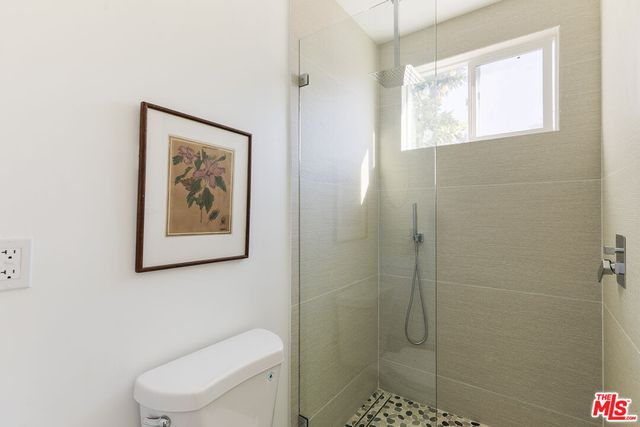 a bathroom with a toilet a sink and shower