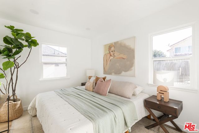 a bedroom with bed and a window