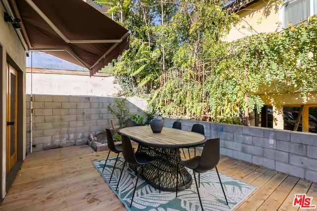 a backyard of a house with table and chairs