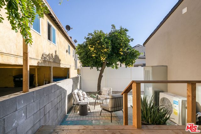 a vase of flowers sitting on a table in front of a building