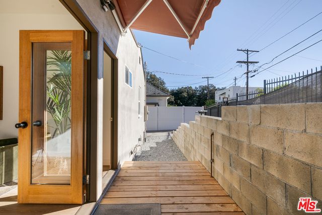 a view of a balcony with wooden floor
