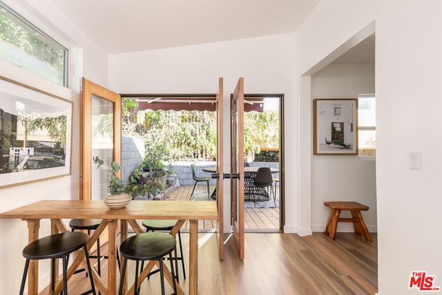 a dining room with furniture and large windows