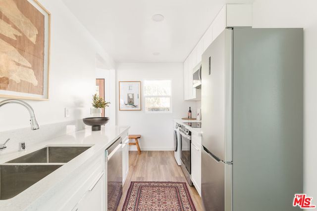 a kitchen with a sink stove and refrigerator