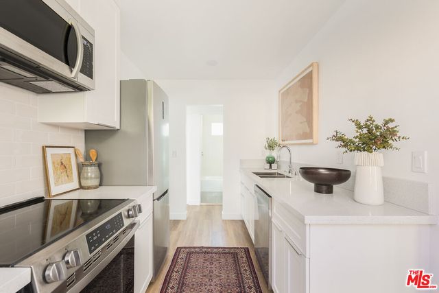a kitchen with a sink stove and cabinets