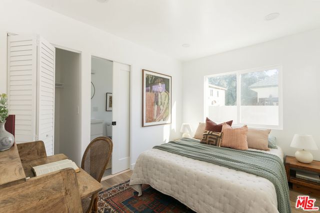 a bedroom with bed and window