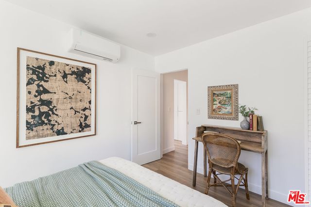 a bedroom with a bed and a desk