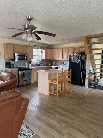 a kitchen with stainless steel appliances granite countertop a stove and refrigerator