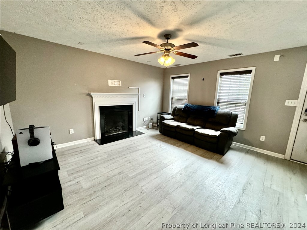 66 Loyalist Road Cameron, NC 28326 - Photo 4 of 24 a living room with furniture and a fireplace