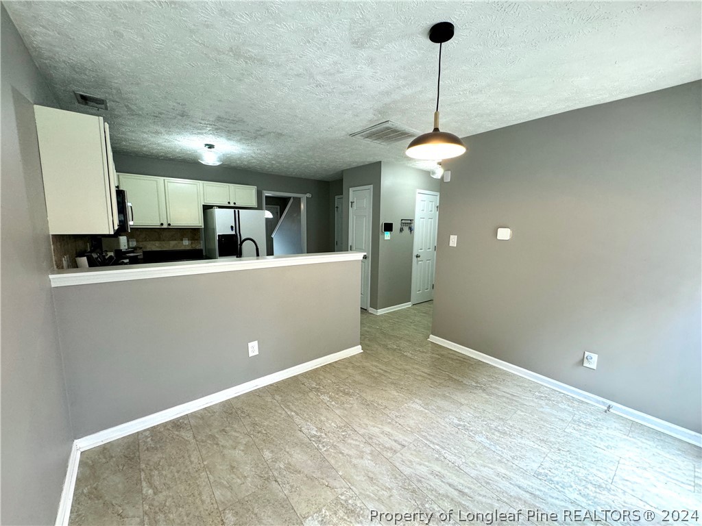 66 Loyalist Road Cameron, NC 28326 - Photo 8 of 24 a kitchen with kitchen island stainless steel appliances a sink cabinets and wooden floor