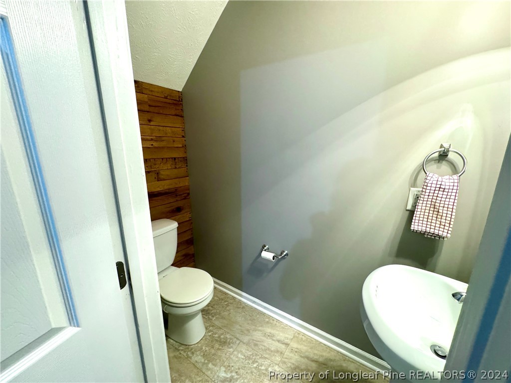 66 Loyalist Road Cameron, NC 28326 - Photo 9 of 24 a bathroom with a toilet and a shower
