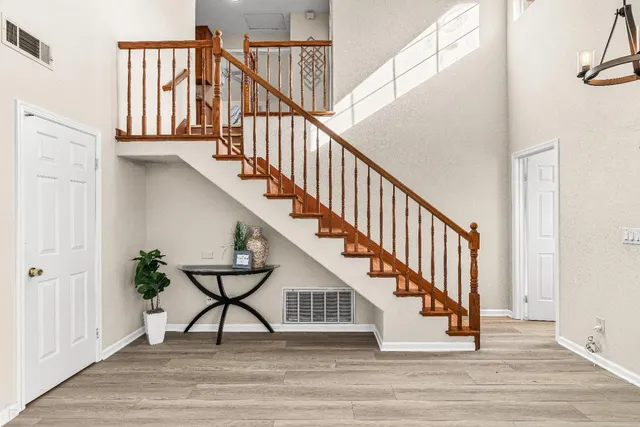 a view of entryway and hall with wooden floor