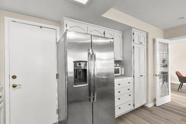a kitchen with cabinets and stainless steel appliances