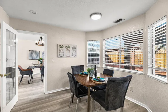 a dining room with furniture and window
