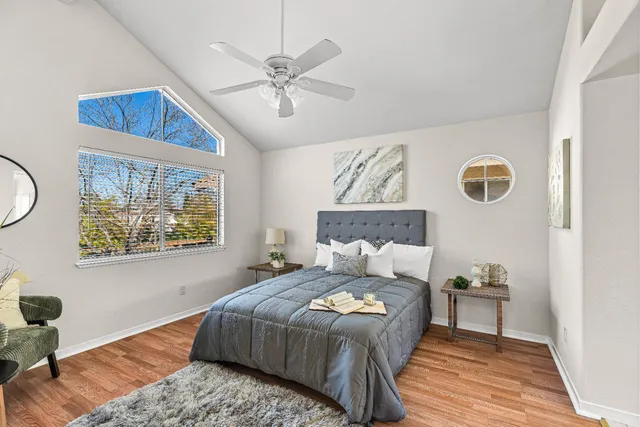 a bedroom with a bed and a chandelier