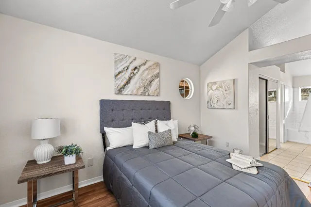 a bedroom with bed and painting on the wall