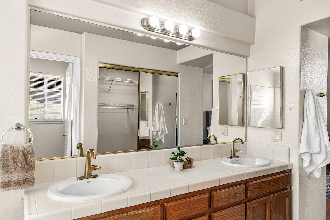 839 Williams Street Tracy, CA 95376 - Photo 34 of 42 a bathroom with double vanity sinks and a mirror