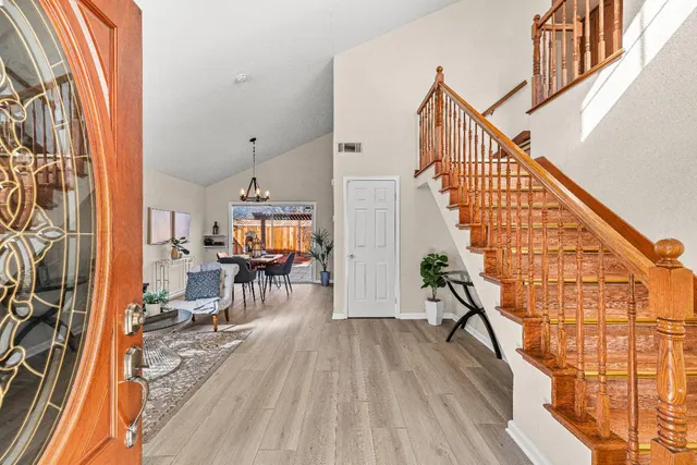 a view of entryway and hall with wooden floor