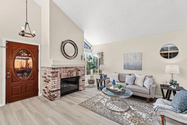 a living room with furniture a fireplace and window