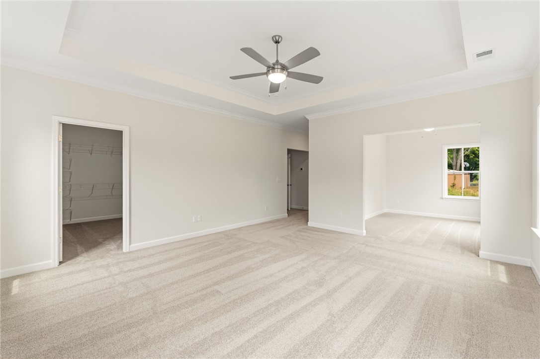 405 Botany Lane Anderson, SC 29621 - Photo 17 of 30 This spacious primary bedroom features soft carpeting and elegant tray ceilings.