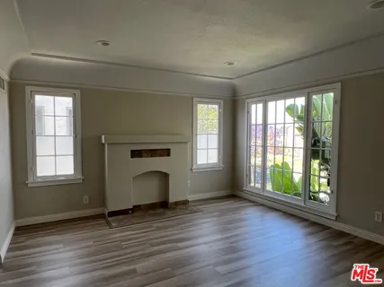 a front view of a house with wooden floor and a window