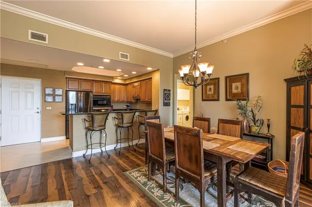 a dining room with furniture and wooden floor