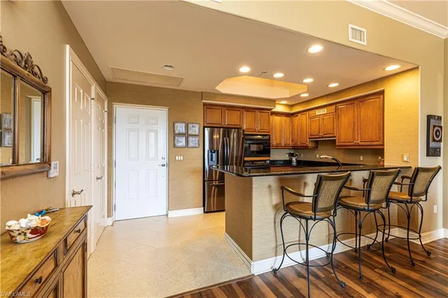 a view of a kitchen with furniture and refrigerator