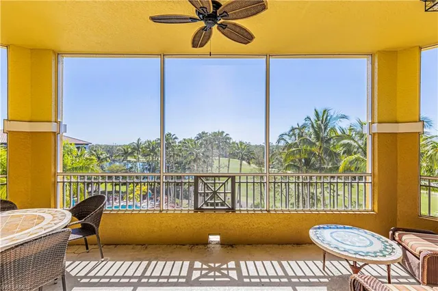 a view of a balcony with table and chairs