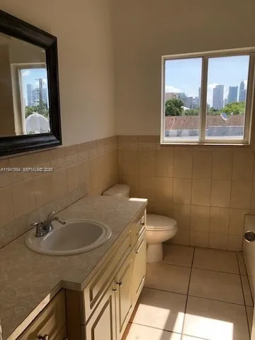 a bathroom with a sink a toilet and mirror