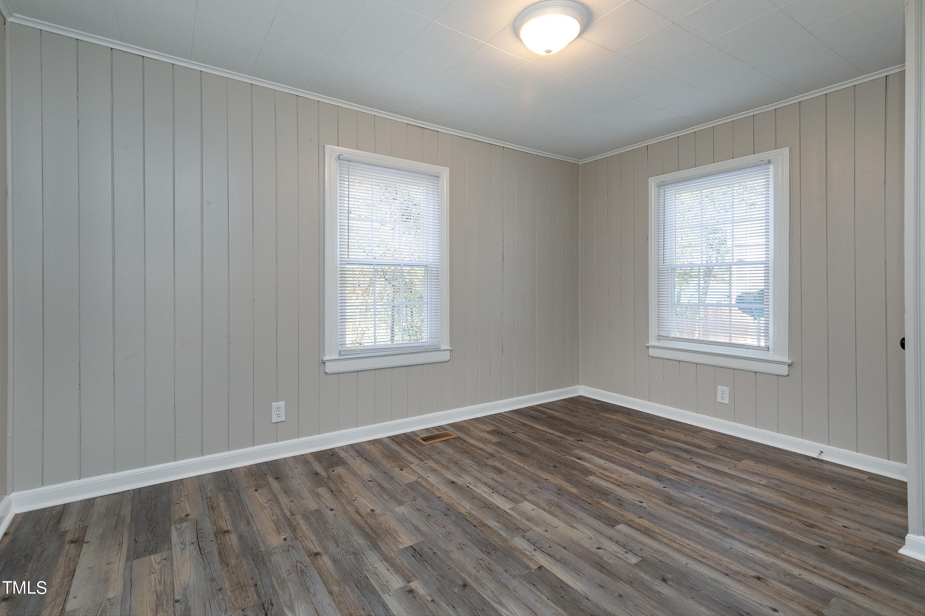 1303 Junction Road Durham, NC 27704 - Photo 14 of 32 a view of an empty room with wooden floor and a window