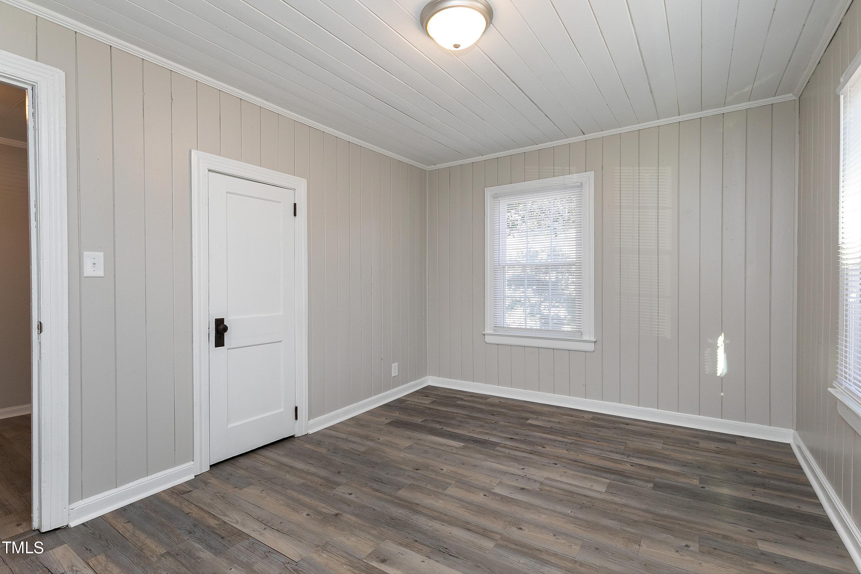1303 Junction Road Durham, NC 27704 - Photo 17 of 32 a view of an empty room with wooden floor and a window
