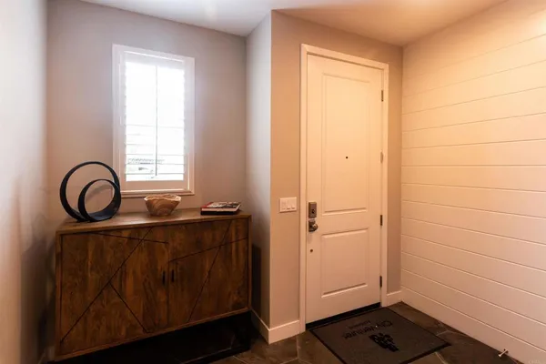 a view of a balcony with chairs and a potted plant