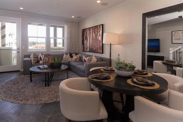 a living room with furniture and a potted plant