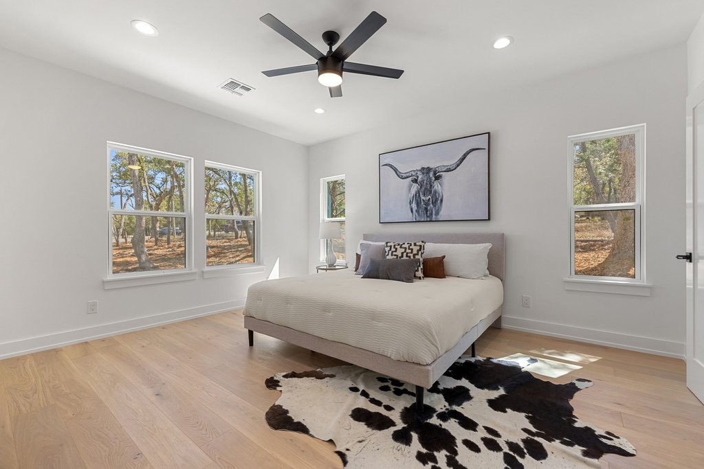 408 Rust Ranch Road Blanco, TX 78606 - Photo 12 of 34 Bedroom featuring ceiling fan, light wood-type flooring, and recessed lighting