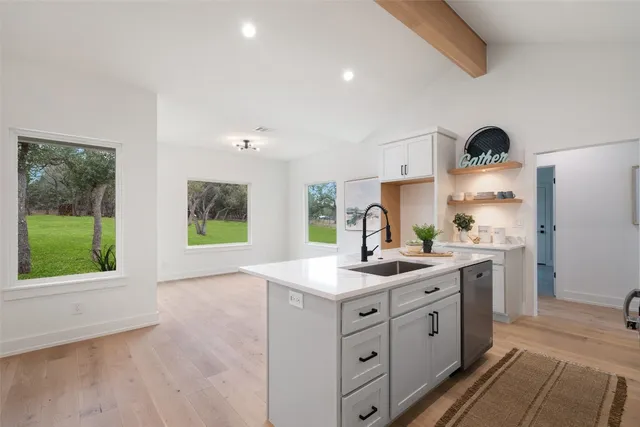 a kitchen with a sink stove and cabinets