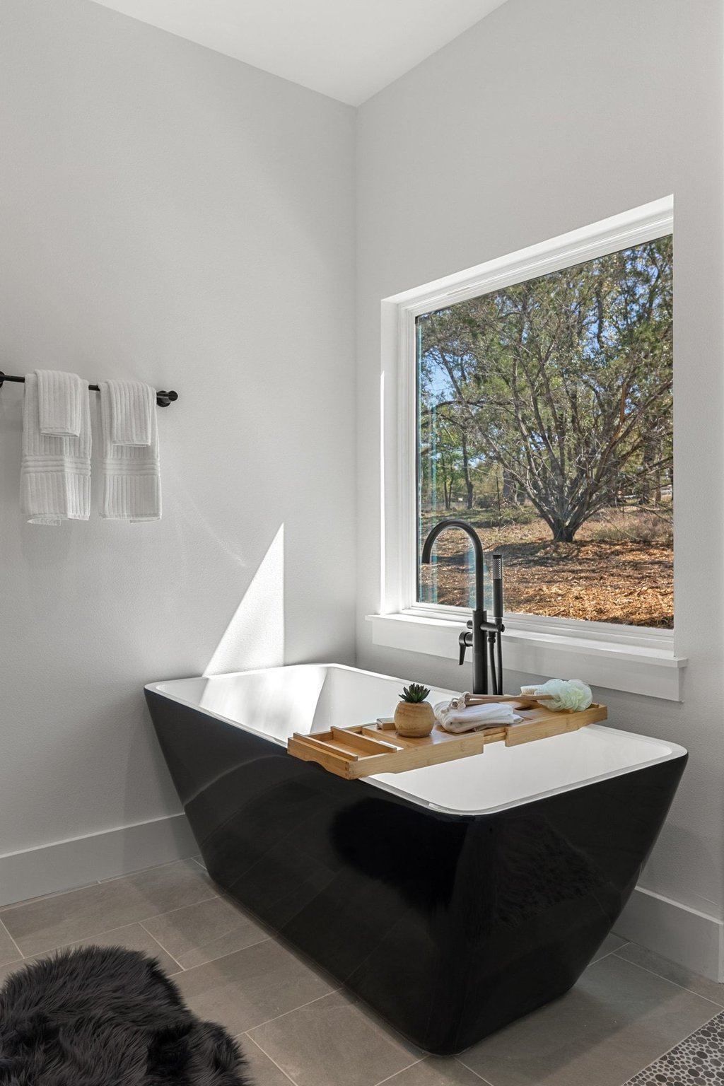 408 Rust Ranch Road Blanco, TX 78606 - Photo 15 of 34 Full bathroom featuring a soaking tub and light tile patterned floors