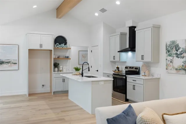 a kitchen with a sink a stove and cabinets