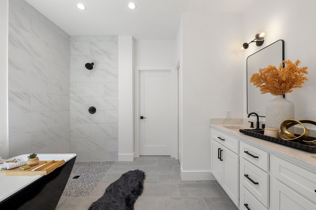 408 Rust Ranch Road Blanco, TX 78606 - Photo 17 of 34 Full bath with double vanity, a walk in shower, recessed lighting, light tile patterned flooring, and a freestanding tub